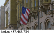 Wrapped around flagpole flag of the USA in Russia Moscow. Стоковое фото, фотограф Фотограф / Фотобанк Лори