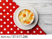Mushroom juliene in bowl on wooden background. Стоковое фото, фотограф Сергей Толмачёв / Фотобанк Лори