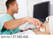 doctor examines a mature woman at abdomen with ultrasound. Стоковое фото, фотограф Яков Филимонов / Фотобанк Лори