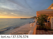 Sochi, Krasnodar Region, Russia, 09 October, 2020: Pierce and cafe on embankment along beach sea at sunset in Loo village. Стоковое фото, фотограф Алексей Антипов / Фотобанк Лори