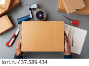 Above table top view of warehouse preparing post courier delivery package. Стоковое фото, фотограф Сергей Толмачёв / Фотобанк Лори