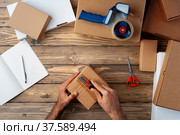 Packing products for delivery on wooden table, top view. Стоковое фото, фотограф Сергей Толмачёв / Фотобанк Лори