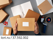 Above table top view of warehouse preparing post courier delivery package. Стоковое фото, фотограф Сергей Толмачёв / Фотобанк Лори