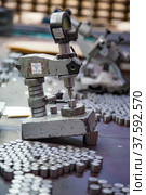 Stepnogorsk, Kazakhstan April 04, 2012: Bearing production plant. Quality control of rollers. Vintage soviet micrometer measuring tool. Редакционное фото, фотограф Alexey Rezvykh / Фотобанк Лори