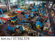 Stepnogorsk, Kazakhstan April 04, 2012: Bearing production plant. Workshop panorama. Production red-hot bearing race parts on conveyor line. Редакционное фото, фотограф Alexey Rezvykh / Фотобанк Лори