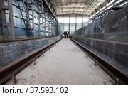 Grey concrete interior of new industrial building. Phosphoric fertilizers plant. Warehouse and railway loading terminal.. Стоковое фото, фотограф Alexey Rezvykh / Фотобанк Лори