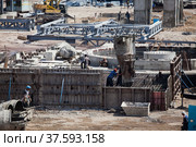Taraz/Kazakhstan: Renovation of phosphate fertilizers plant. Construction of reinforcement concrete foundation (basement) of industrial building. With form work and concrete bucket. Стоковое фото, фотограф Alexey Rezvykh / Фотобанк Лори