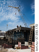 Phosphate fertilizers plant. Construction of reinforcement concrete foundation (basement) with mobile crane and forms. Developing structure of industrial building. Taraz, Kazakhstan. Стоковое фото, фотограф Alexey Rezvykh / Фотобанк Лори
