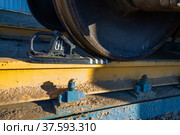 Hopper car railroad terminal. Phosphate fertilizers plant. Wagon wheel with brake shoe Close-up. Yellow clay dirt on rail. Стоковое фото, фотограф Alexey Rezvykh / Фотобанк Лори