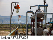 Equipment on oil refinery plant on the sky and mountain background. Kazakhstan, Taraz city. Стоковое фото, фотограф Alexey Rezvykh / Фотобанк Лори