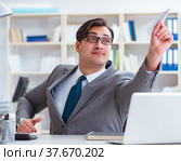 Businessman with paper airplane in office. Стоковое фото, фотограф Elnur / Фотобанк Лори