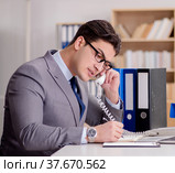 Businessman speaking on phone in office. Стоковое фото, фотограф Elnur / Фотобанк Лори