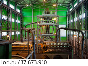 Gold ore modern refining plant. Gold gravity spiral chute concentrator (tin ore spiral) and magnetic drum separators on background. Стоковое фото, фотограф Alexey Rezvykh / Фотобанк Лори