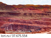 Heaps of spoil in aluminium ore quarry. Bauxite clay open cast (open cut) mining. Light blue sky with clouds. White road and small quarry lake down. Стоковое фото, фотограф Alexey Rezvykh / Фотобанк Лори