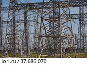 Electric distributing substation elements. Pylons, towers and cables. Blue sky background. Стоковое фото, фотограф Alexey Rezvykh / Фотобанк Лори
