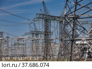 Electric towers and cables on transformer and Distribution substation. Blue sky background. Стоковое фото, фотограф Alexey Rezvykh / Фотобанк Лори