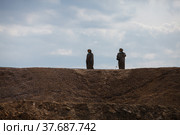 Almaty region, Kazakhstan - June 04, 2012: Mining and processing plant of Altynalmas company. Chemist use sodium cyanide NaCN for gold refining. Hazmat suits and gas masks. Стоковое фото, фотограф Alexey Rezvykh / Фотобанк Лори
