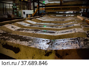 Temirtau, Kazakhstan - June 09, 2012: Concrete sleepers manufacturing plant NORD Prom NS. Close-up photo. Low depth of field. Стоковое фото, фотограф Alexey Rezvykh / Фотобанк Лори