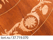 Decorative inlay carving of round wooden table. Стоковое фото, фотограф EugeneSergeev / Фотобанк Лори