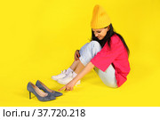 Young girl touching a heel shoes with disgust. Стоковое фото, фотограф Art Konovalov / Фотобанк Лори