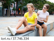 Girl asks girlfriend for forgiveness. Girl is unhappy upset there is no reluctance to talk. Стоковое фото, фотограф Яков Филимонов / Фотобанк Лори