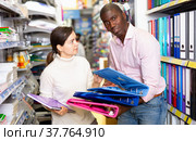 Couple of African man and Caucasian woman at stationery shop. Стоковое фото, фотограф Яков Филимонов / Фотобанк Лори