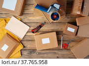 Packing products for delivery on wooden table, top view. Стоковое фото, фотограф Сергей Толмачёв / Фотобанк Лори