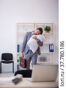 Young male employee in oversleeping concept. Стоковое фото, фотограф Elnur / Фотобанк Лори