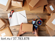 Packing products for delivery on wooden table, top view. Стоковое фото, фотограф Сергей Толмачёв / Фотобанк Лори