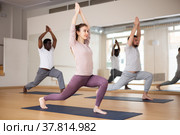 Woman standing in Ashta Chandrasana with hands in namaste over head. Стоковое фото, фотограф Яков Филимонов / Фотобанк Лори