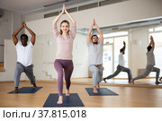 Woman standing in Ashta Chandrasana with hands in namaste over head. Стоковое фото, фотограф Яков Филимонов / Фотобанк Лори
