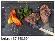 Roasted lamb leg served with grilled organic vegetable and peppe closeup. Стоковое фото, фотограф Яков Филимонов / Фотобанк Лори