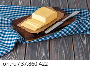 Wooden board with butter on blue checkered napkin. Стоковое фото, фотограф Сергей Толмачёв / Фотобанк Лори