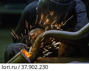 Welder repairing a car exhaust pipe. Стоковое фото, фотограф Юрий Бизгаймер / Фотобанк Лори