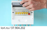 Consumer unit switchgear with circuit breakers, homeowner switches switch. Стоковое видео, видеограф Владимир Григорьев / Фотобанк Лори
