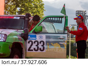 Туркменский пилот Тойлыев  Шохрат на автомобиле Nissan Patrol во время торжественной церемонии награждения участников международного ралли "Шелковый путь" в "Лужниках", города Москва, Россия (2022 год). Редакционное фото, фотограф Николай Винокуров / Фотобанк Лори