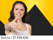 Closeup portrait of young pretty unhappy, serious woman pointing at someone as if to say you did something wrong. Стоковое фото, фотограф Сергей Толмачёв / Фотобанк Лори