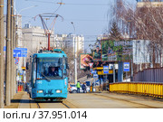 Minsk, Belarus - March 25, 2022: A tram moves along the rails on Chapaev Street in Minsk. The model of the tram AKSM-60102 of Belarusian production. Редакционное фото, фотограф Denis Shitikoff / Фотобанк Лори