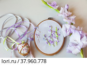 The embroidery process with satin ribbons of light-violet gladiolus flowers on light  background. Flat lay, top view, copy space (Embroidery with satin ribbons were performed by author of the images) Стоковое фото, фотограф Виктория Катьянова / Фотобанк Лори