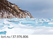 Lake Baikal in the winter season. The coast near the village of Bolshoe Goloustnoe. Snow-covered field of impassable ice hummocks of blue transparent ice. Beautiful winter landscape. Стоковое фото, фотограф Виктория Катьянова / Фотобанк Лори
