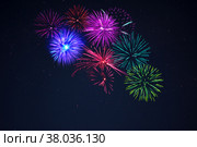 Pink purpe blue green fireworks over starry sky. Стоковое фото, фотограф TasiPas / Фотобанк Лори