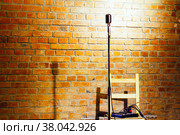 Microphone ready on stage against a brick wall ready for the Karaoke performer (2021 год). Стоковое фото, фотограф Евгений Ткачёв / Фотобанк Лори
