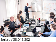Informal IT business startup company meeting. Team leader discussing and brainstorming new project and ideas with colleagues. Startup business and entrepreneurship concept. Стоковое фото, фотограф Matej Kastelic / Фотобанк Лори