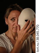A young woman with a white theatrical mask in her hands. Стоковое фото, фотограф Boris Vasilenko / Фотобанк Лори