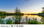 Lake at sunset in calm weather. View from the shore. Стоковое фото, фотограф Михаил Аккуратoв / Фотобанк Лори