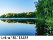 Beaitiful landscape of Lake Haukivesi during sunrise. Light fog over the water. Specular reflection in the water.  Saimaa lake system, Rantasalmi, Savo, Finland. Стоковое фото, фотограф Михаил Аккуратoв / Фотобанк Лори