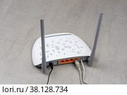 New white Wi-Fi router with gray antennas on a grey background rear view. Стоковое фото, фотограф Андрей С / Фотобанк Лори