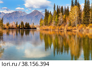 Picturesque autumn landscape with reflection of mountains and yellowed forest in calm blue water. Buryatia, Tunka foothill valley. Стоковое фото, фотограф Виктория Катьянова / Фотобанк Лори