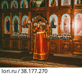 Adygea, Russia - November 8, 2017: a young deacon censes the censer before the altar at the divine Liturgy in the Orthodox Church. Редакционное фото, фотограф Андрей С / Фотобанк Лори