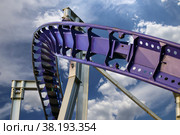 Attraction roller-coaster (switchback) on the background of the cloudy sky. Стоковое фото, фотограф Владимир Журавлев / Фотобанк Лори